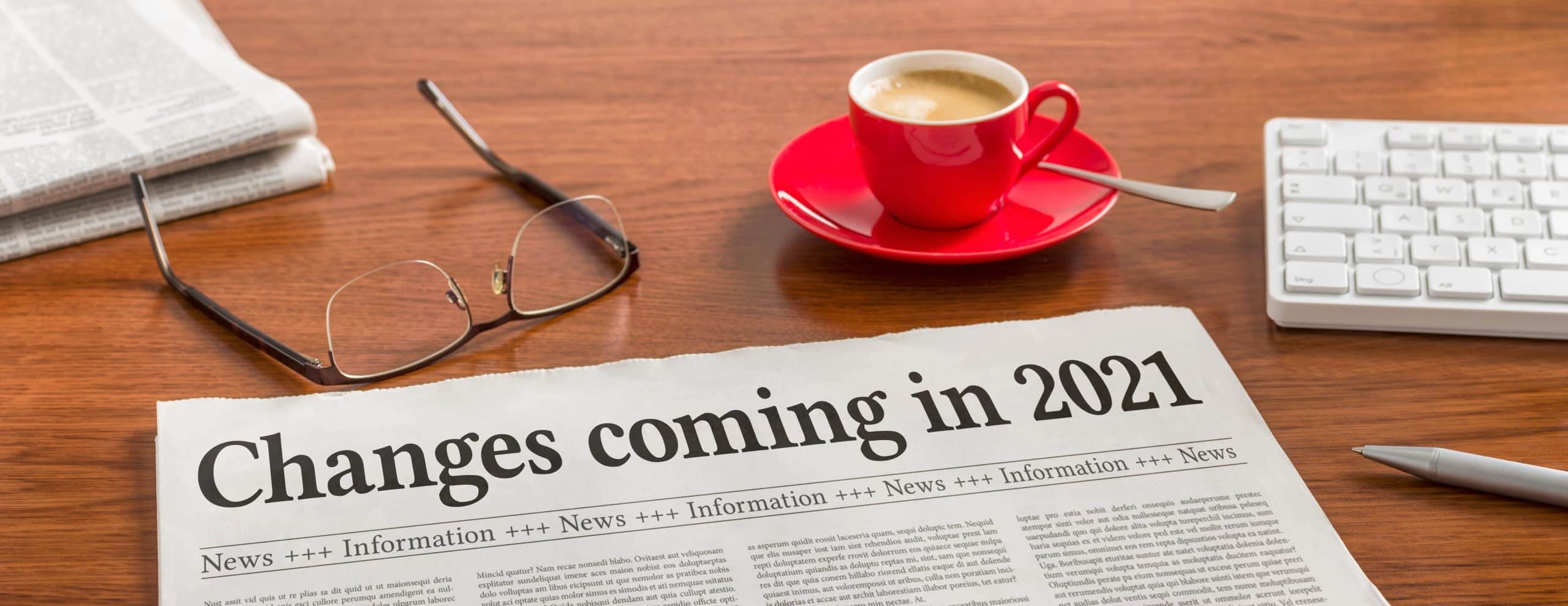 A newspaper on a wooden desk – Changes coming in 2021 April Webinar Image